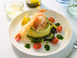 Gourmet shrimp dish with wine, fine dining on American Cruise Lines river cruise.