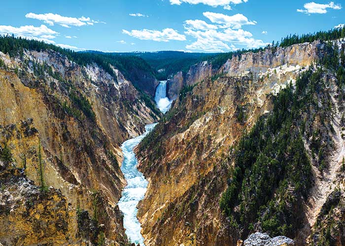 Waterfall and canyon scenery at Yellowstone National Park experienced on a guided national parks cruise excursion